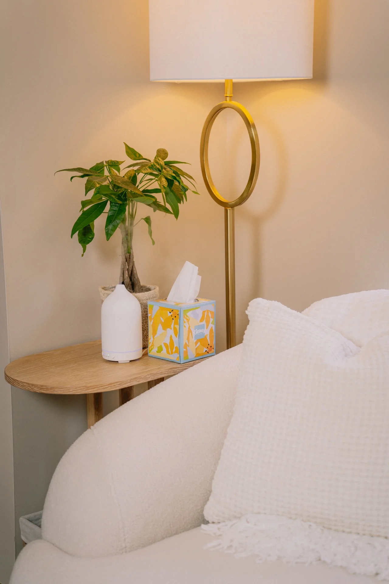 Cozy corner of the Bluprint Counseling office with an armchair, plant, and diffuser